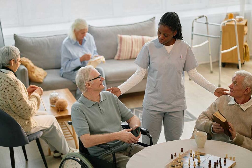 A senior resident decorating a cozy room with personal items and family photos.