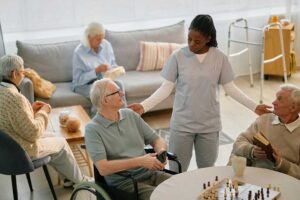 A senior resident decorating a cozy room with personal items and family photos.